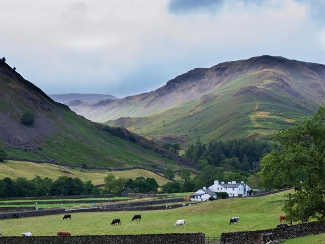 Grasmere village with mountains in the background, Cumbria, Lake District, UK.