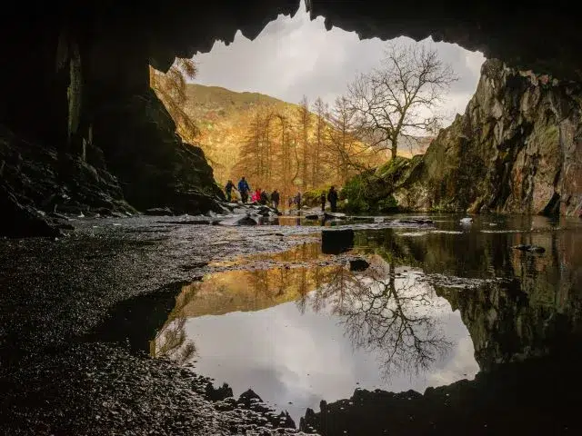 Rydal Cave refections in the water on a sunny day.